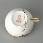 Bottom view of a Kintsugi-repaired Early Noritake tea cup, a testament to a philosophy of care and mindful object creation.