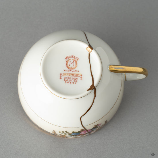 Bottom view of a Kintsugi-repaired Early Noritake tea cup, a testament to a philosophy of care and mindful object creation.