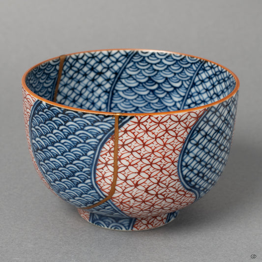 Front view of an authentic Kyoto ware tea cup, showcasing its overall form and the elegant lines of its 24k gold Kintsugi repair.