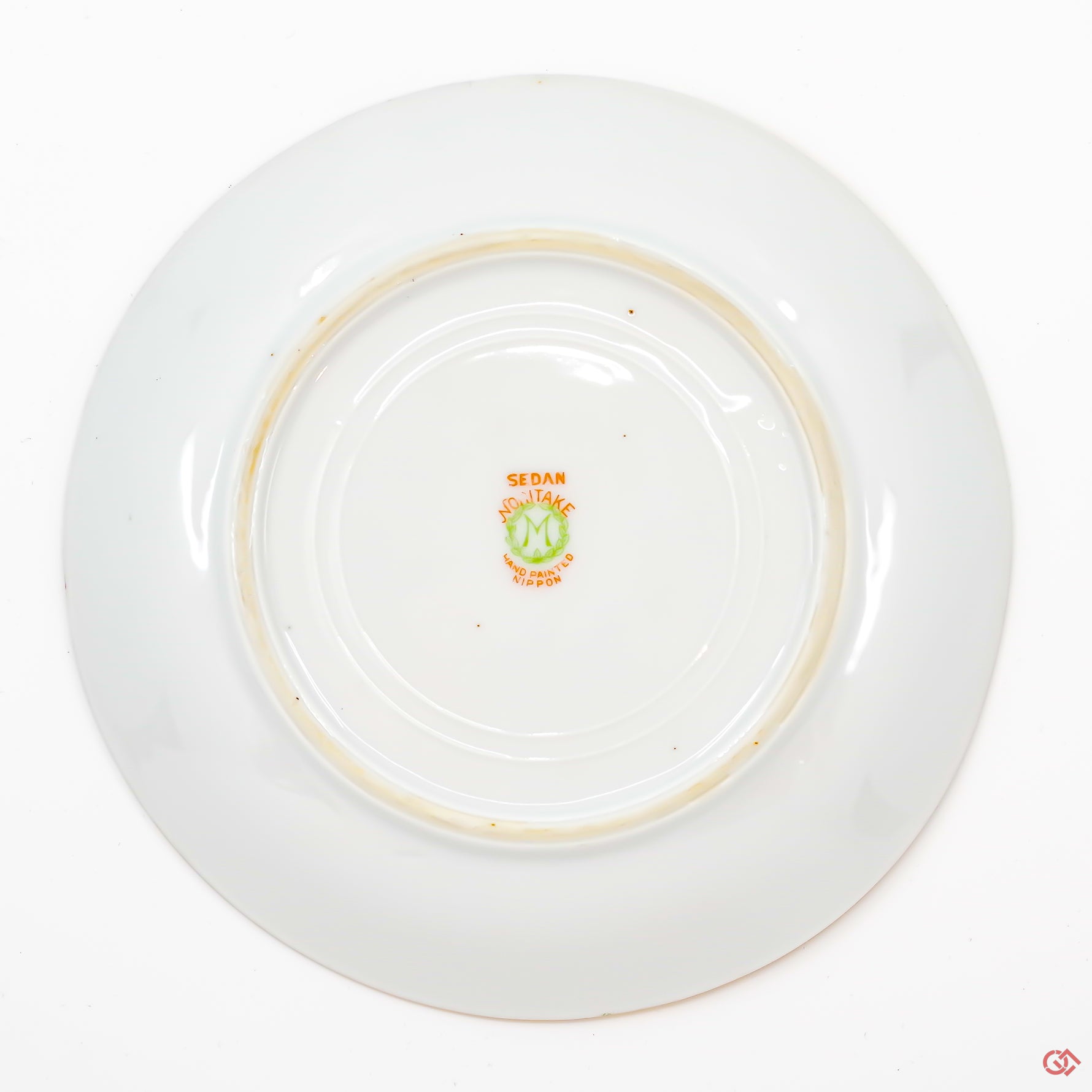 A photo of the bottom of an authentic Kintsugi pottery piece, showing its overall design and features.