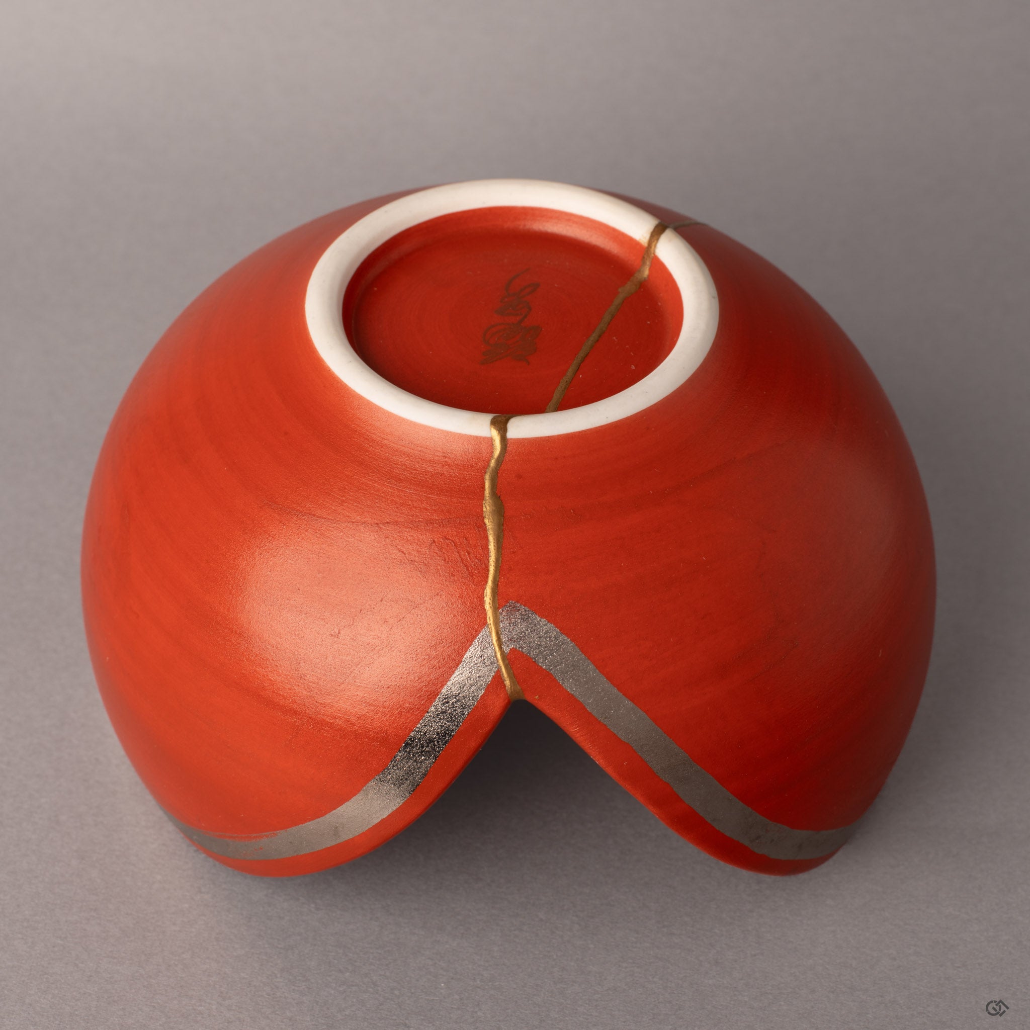 Detail of 24K gold kintsugi against matte red glaze, where Arita precision meets bold modern sensibility.