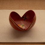 An Arita kintsugi bowl rests on tatami, the painted swallow catching light—a symbol of homecoming made tangible.