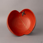 Looking into this Arita kintsugi bowl reveals the hand-painted swallow soaring across mended red porcelain.
