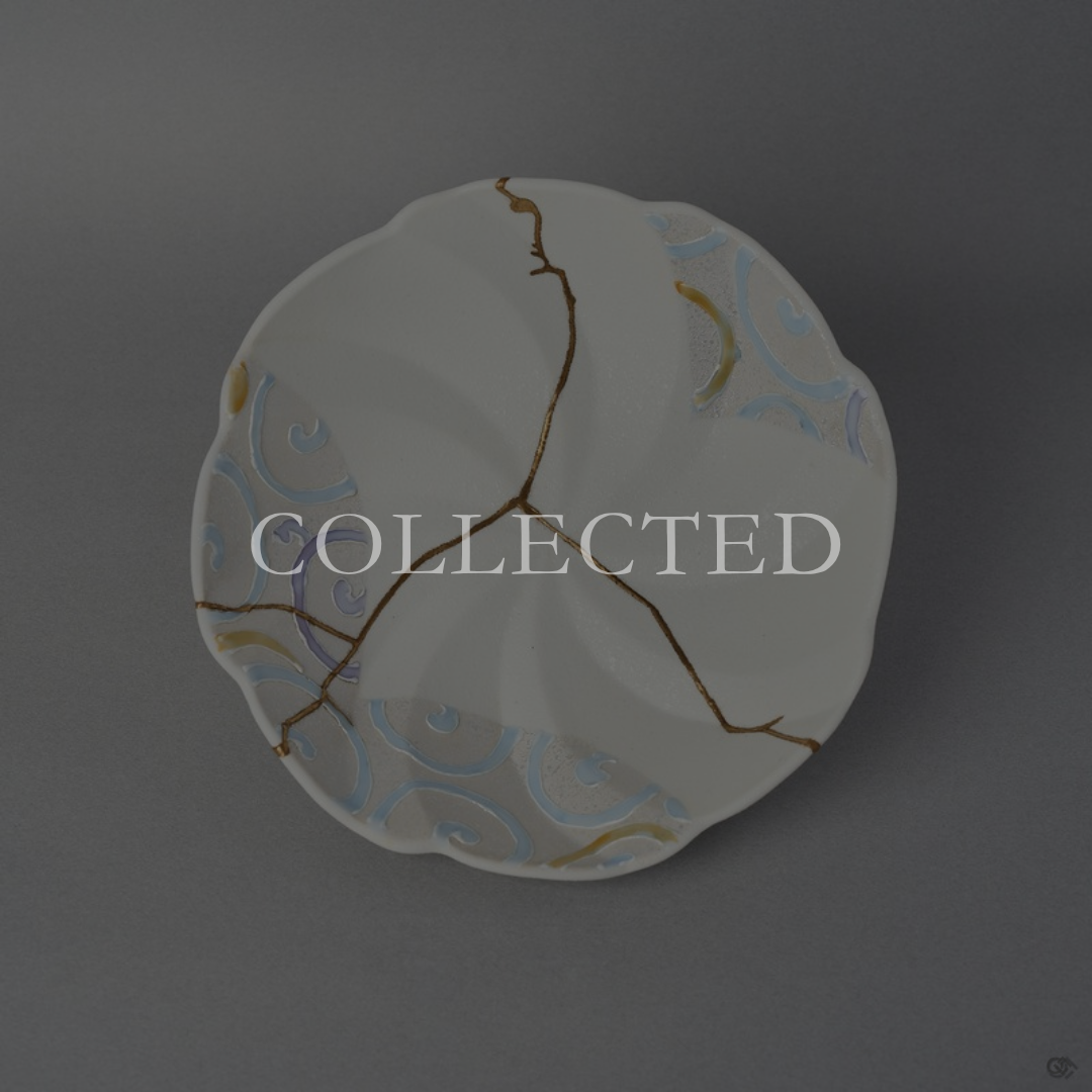 Arita ware bowl in matte white porcelain with pastel swirl panels, its break rejoined with natural urushi, 24K gold on the face and moss-green urushi beneath. Collected.