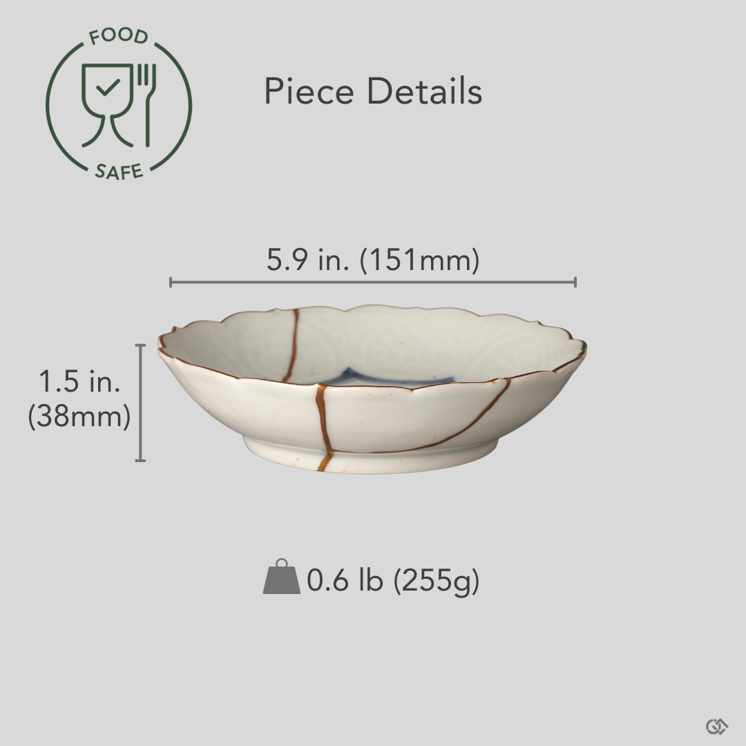 Kintsugi Ko-Imari bowl with diameter, height, and weight overlaid on its front view; a single gold seam crosses the cobalt landscape, one of a kind.