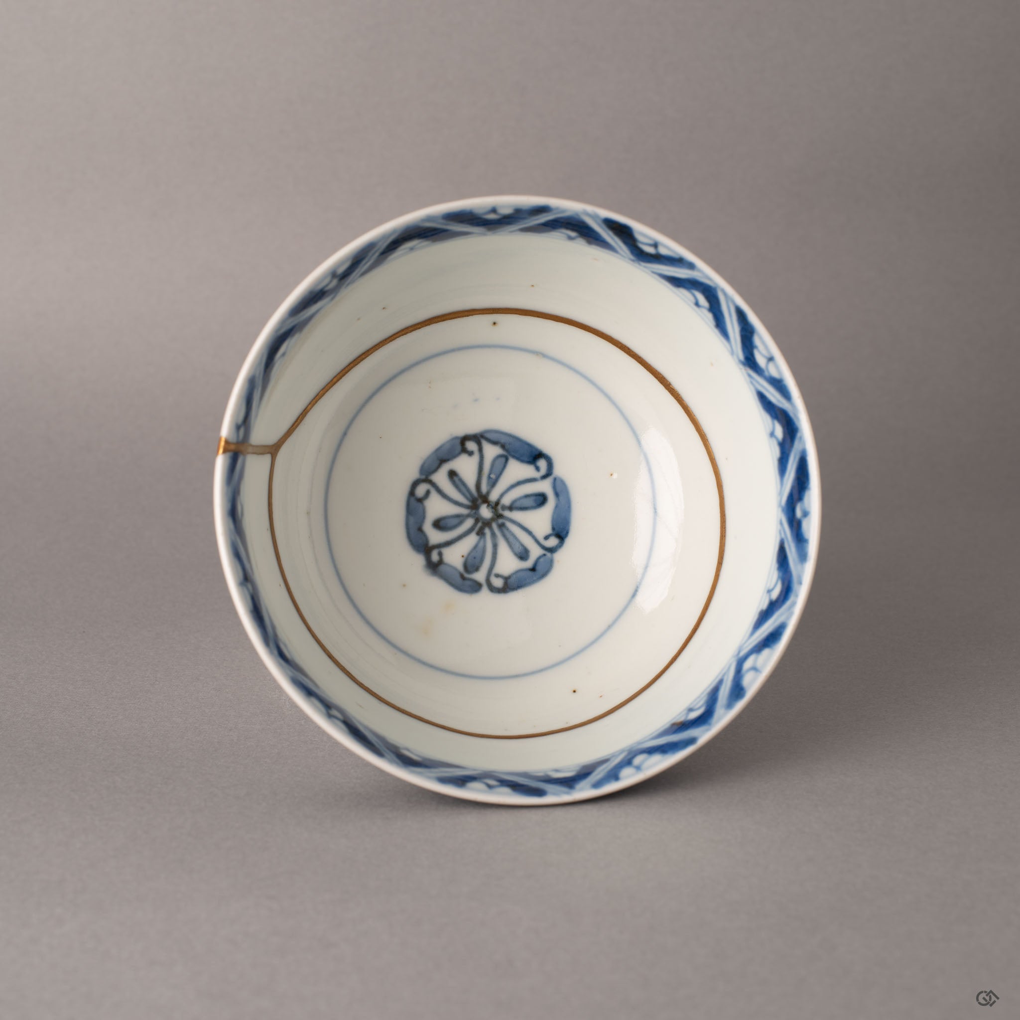 Top view of kintsugi Ko-Imari bowl showing full interior sometsuke pattern intersected by 24K gold restoration, a story in every seam.