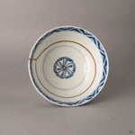 Top view of kintsugi Ko-Imari bowl showing full interior sometsuke pattern intersected by 24K gold restoration, a story in every seam.
