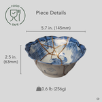 Ko-Imari bowl in blue-and-white porcelain with 24K gold and pure silver kintsugi seams, restored with natural urushi, shown beside an object for scale reference.