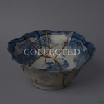 Ko-Imari blue-and-white porcelain bowl with a cobalt sage-and-bamboo interior, foliate rim, 24K gold kintsugi seams within and pure silver seams outside, restored with natural urushi. Sold out.