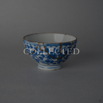 Edo-period Ko-Imari sake cup with hand-painted karakusa vines in sometsuke blue, restored with draped 24K gold kintsugi arcs in natural urushi. Collected.
