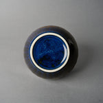 Kintsugi bowl base with white foot ring and speckled night-blue glaze, the gold urushi seam visible at the upper edge.