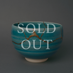 Sold out: kintsugi Kyoto ware matcha bowl in turquoise crackle glaze with 24K gold seams crossing the rounded body.