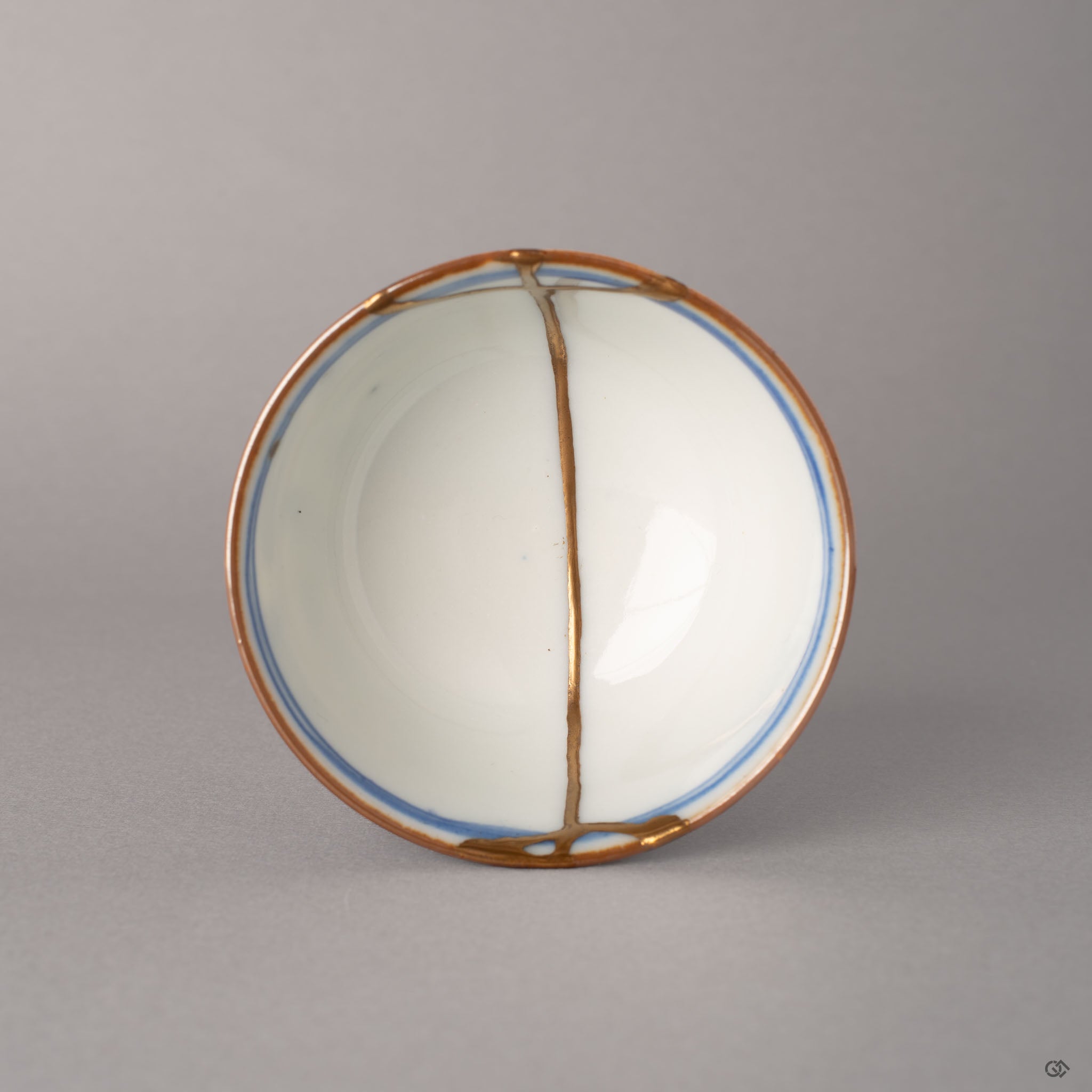 Top view of kintsugi Ko-Imari cup with gold lines radiating across the rim and interior, food-safe urushi craftsmanship from above.