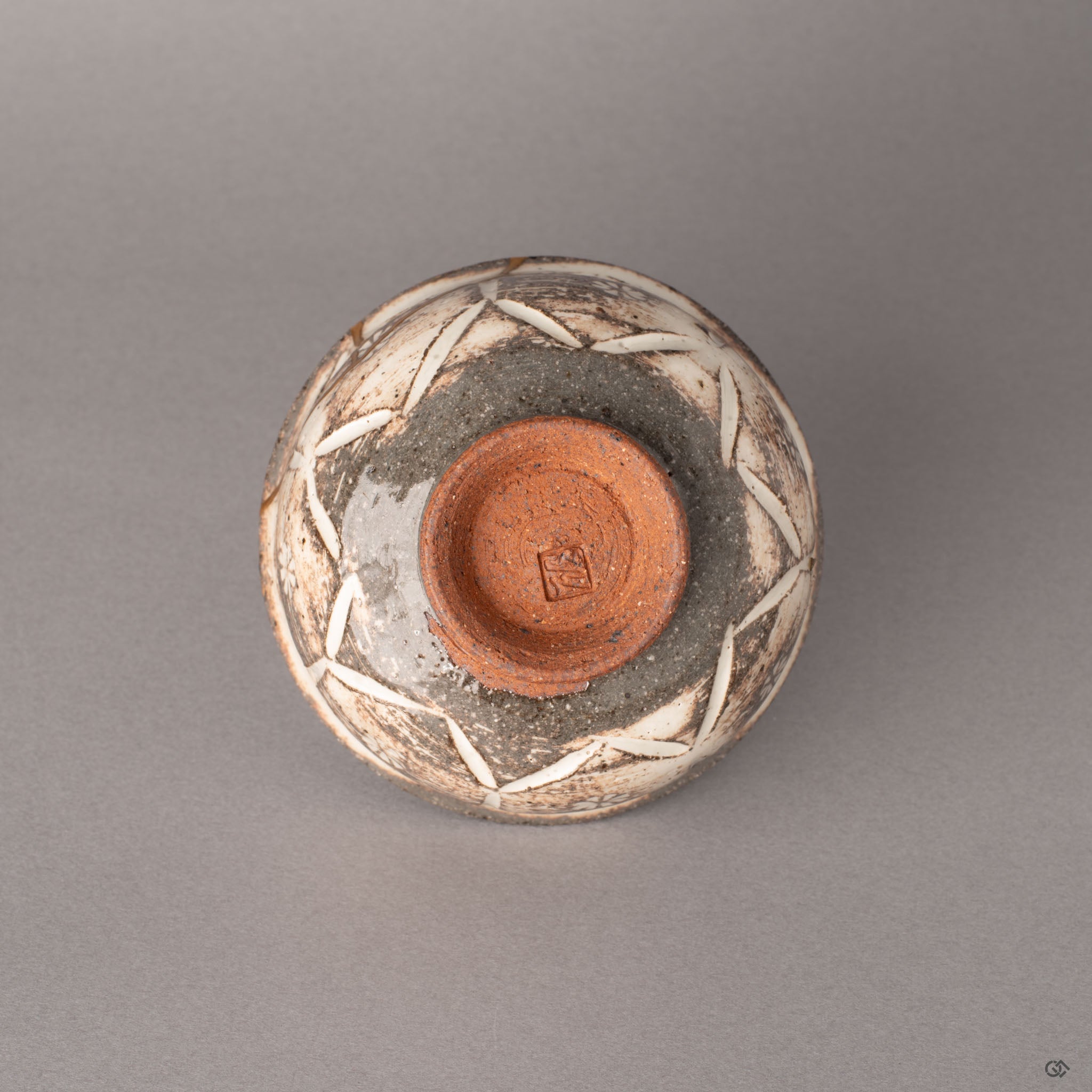 Unglazed terracotta foot of a Kyoto ware kintsugi cup, the earthy texture revealing centuries-old ceramic tradition in its clay body.