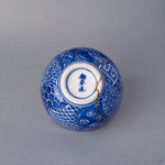 Bottom view of the Kyoto ware kintsugi cup showing the trimmed footring, sometsuke blue line work, and the base of the 24K gold restoration seam.