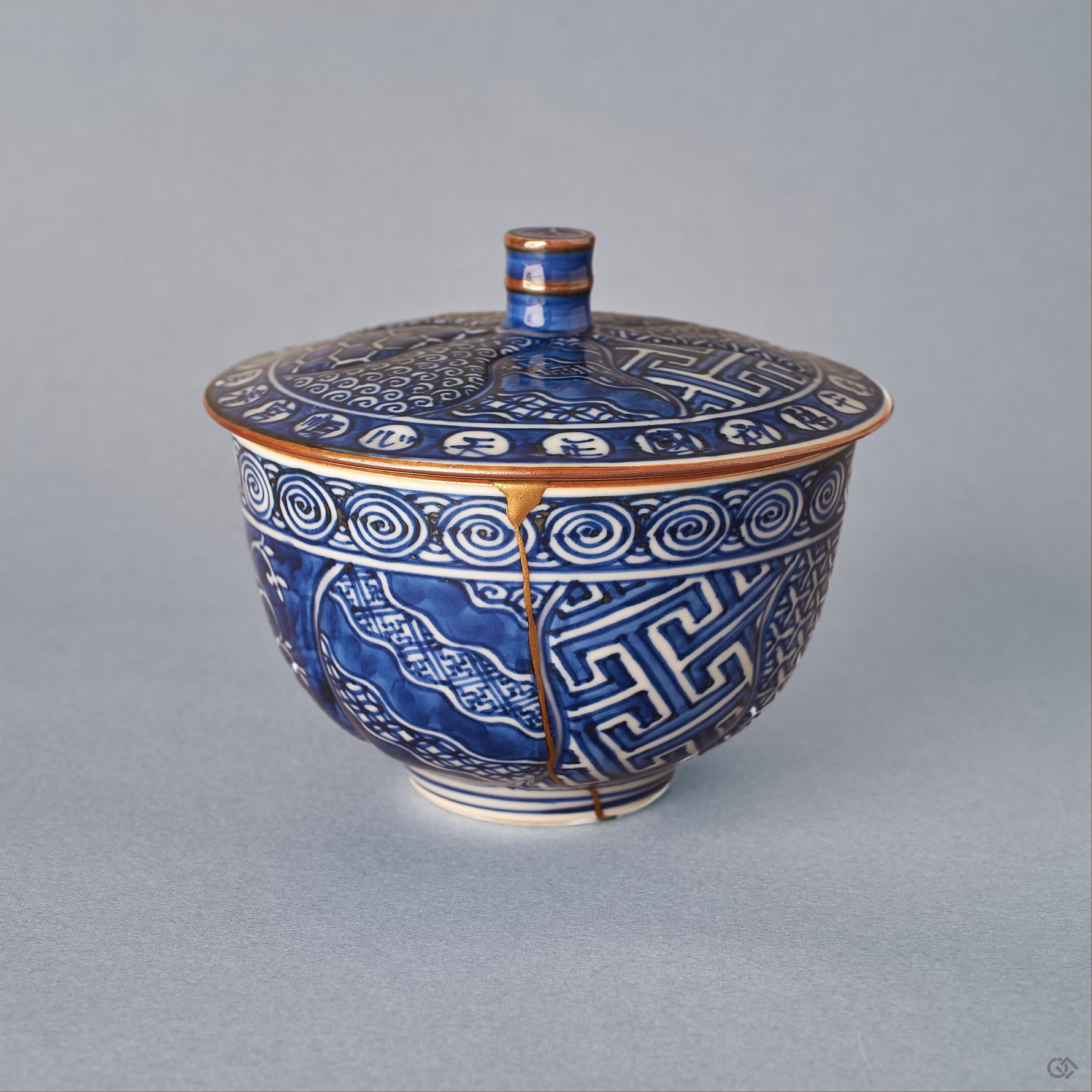 Kyoto ware porcelain cup, sometsuke cobalt blue with Uzu-komon swirls, single 24K gold kintsugi seam from rim to foot, lidded form, front view.