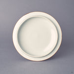 Underside of the Kyoto ware cup lid, white porcelain with sometsuke blue edge, fitted profile, gold-banded rim from the 24K gold kintsugi work.