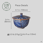 Kyoto ware kintsugi cup held in hand for scale, lidded sometsuke blue porcelain with 24K gold restoration seam, showing the covered cup's size.