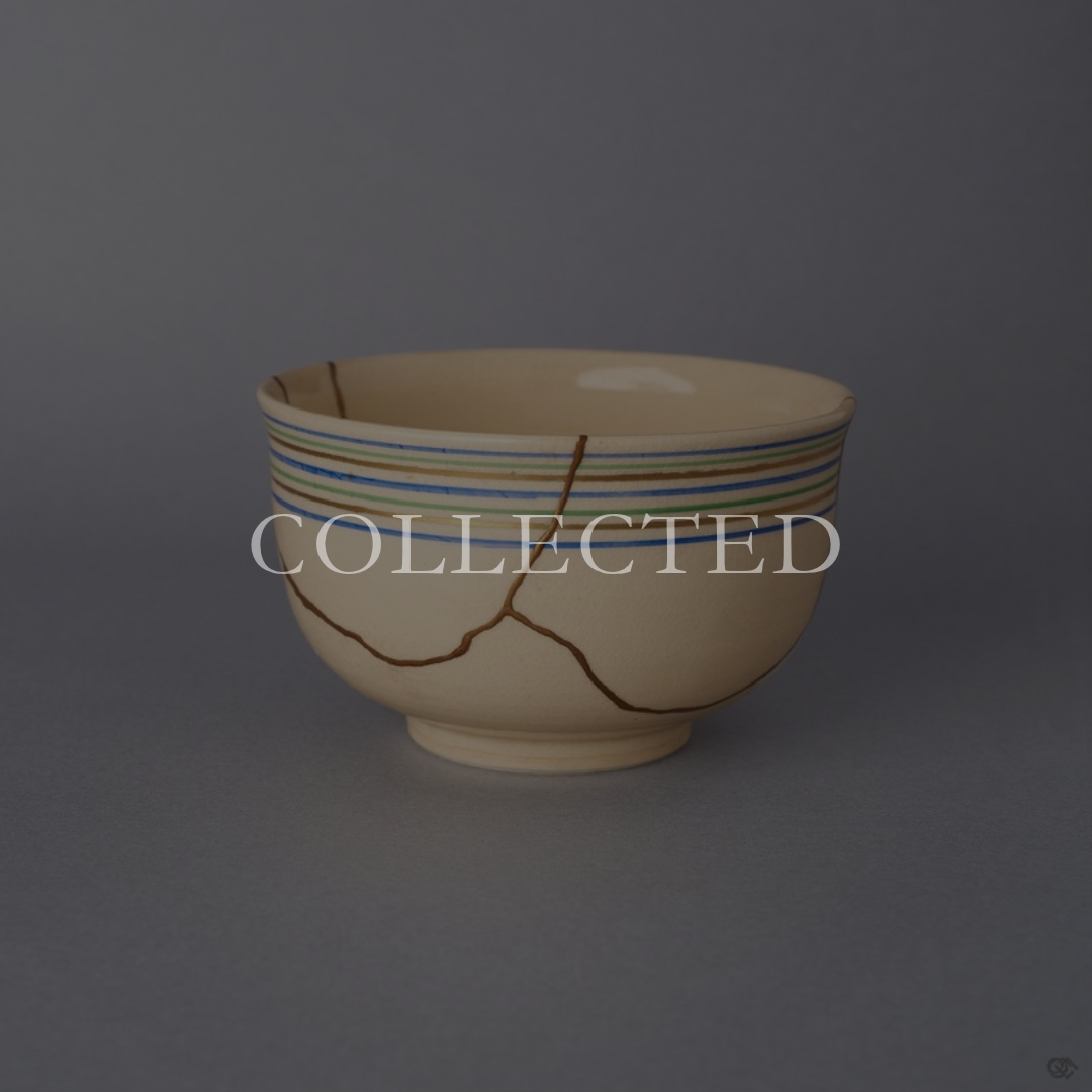 Kyoto ware kintsugi cup in cream colored earthenware, with blue, green, and gold rim lines and a network of seams restored in 24K gold, shown front view. Collected.