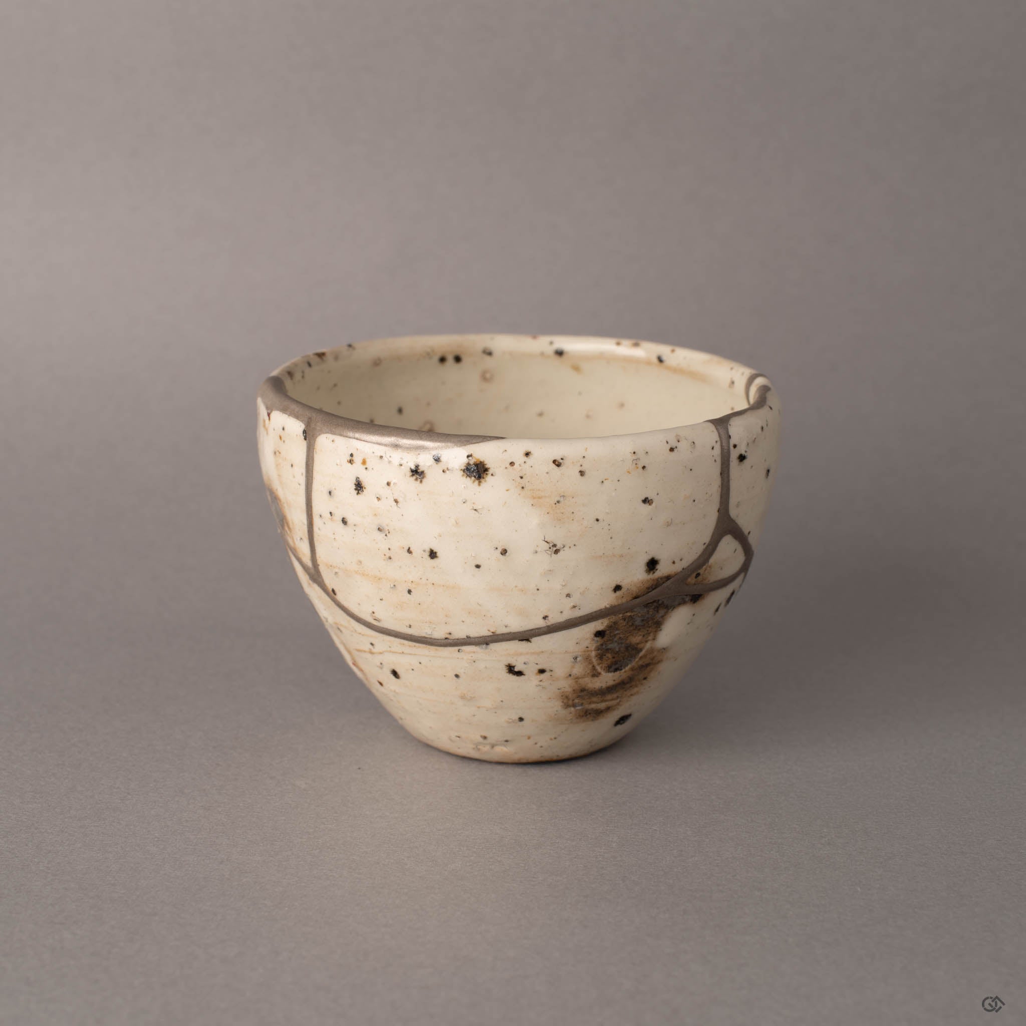 Third side view of Shigaraki kintsugi cup with pure silver seams on ivory earthenware, enduring legacy.