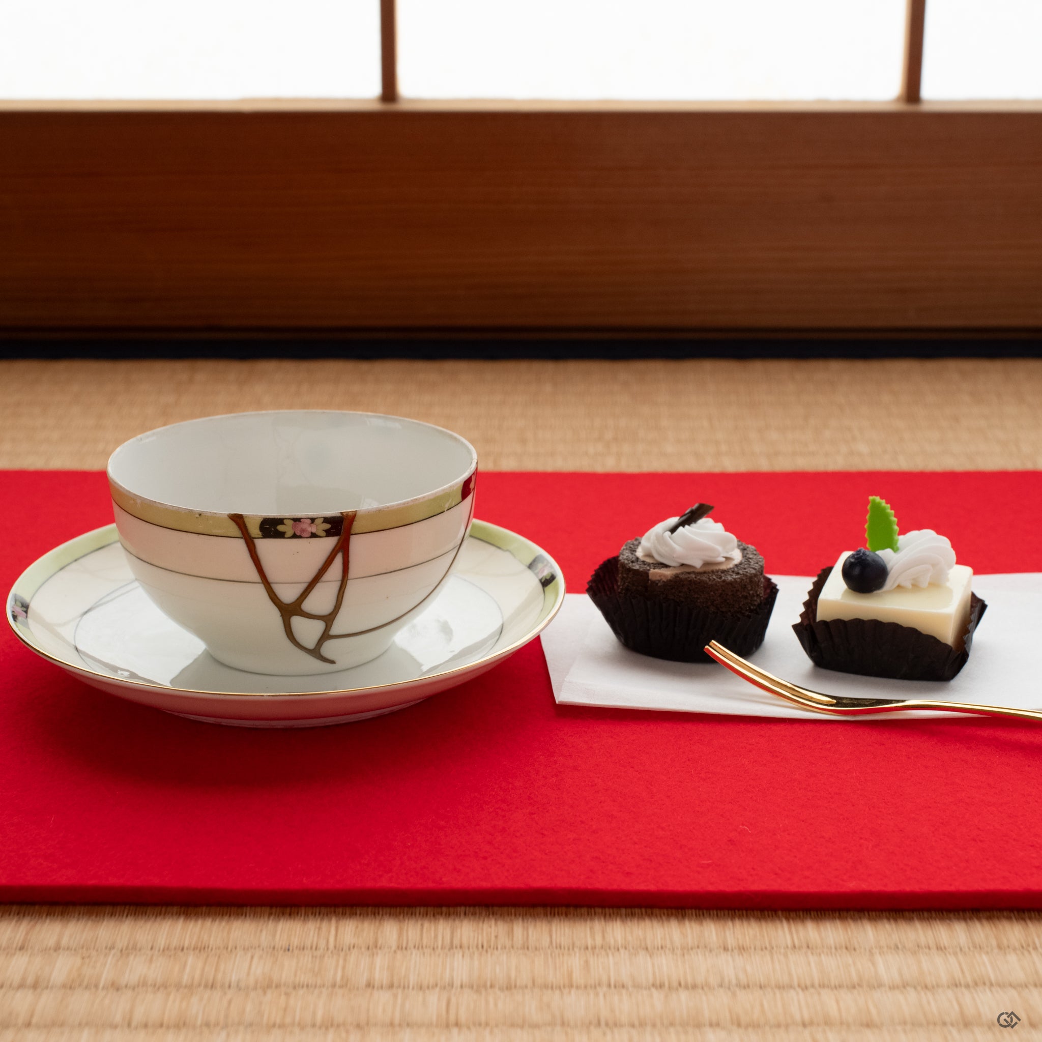 Kintsugi cup and saucer on tatami with soft light—restored with urushi and gold, evoking spiritual elegance in everyday ritual.