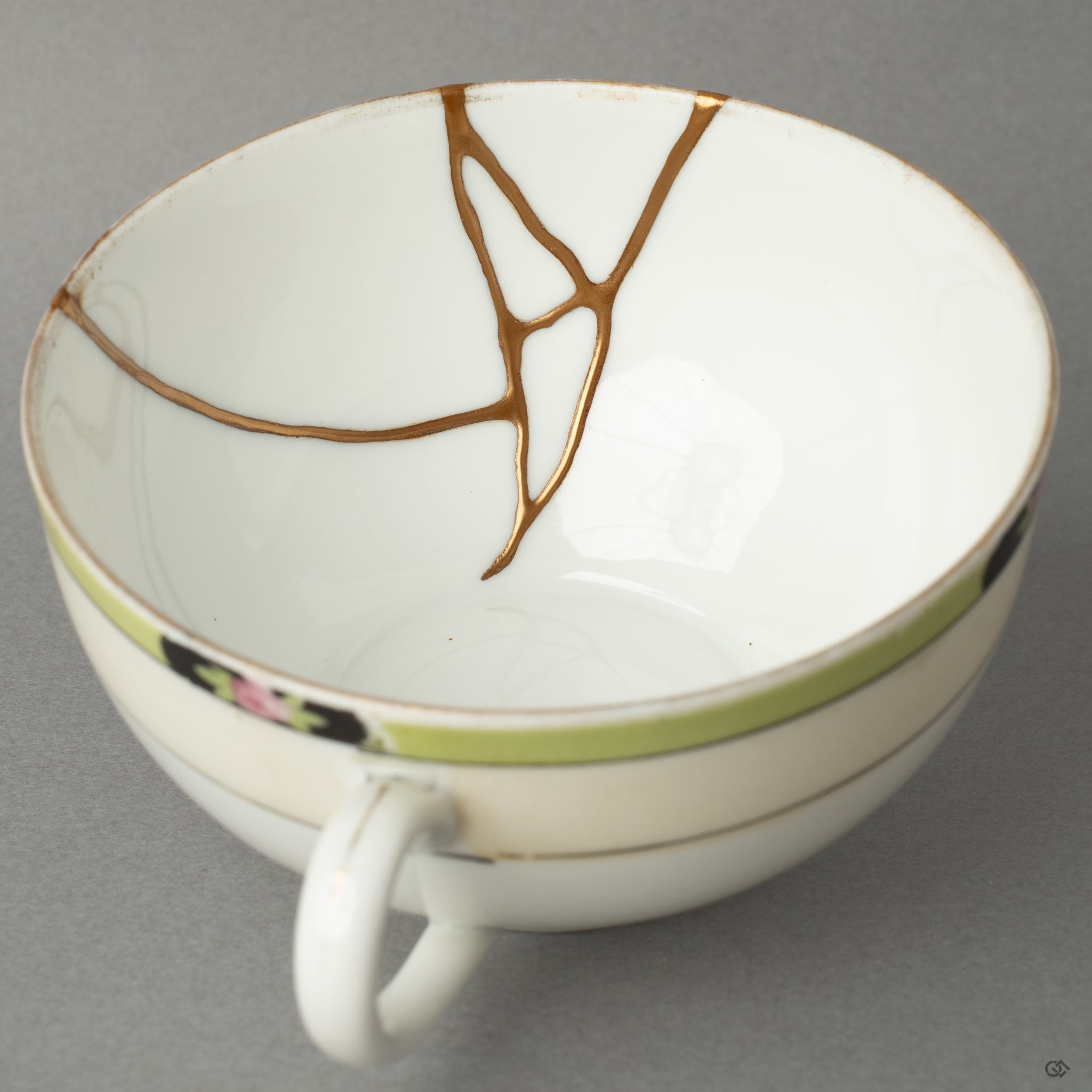 Interior close-up of a kintsugi cup’s golden seam—inviting a moment of contemplation within its quiet, tactile history.