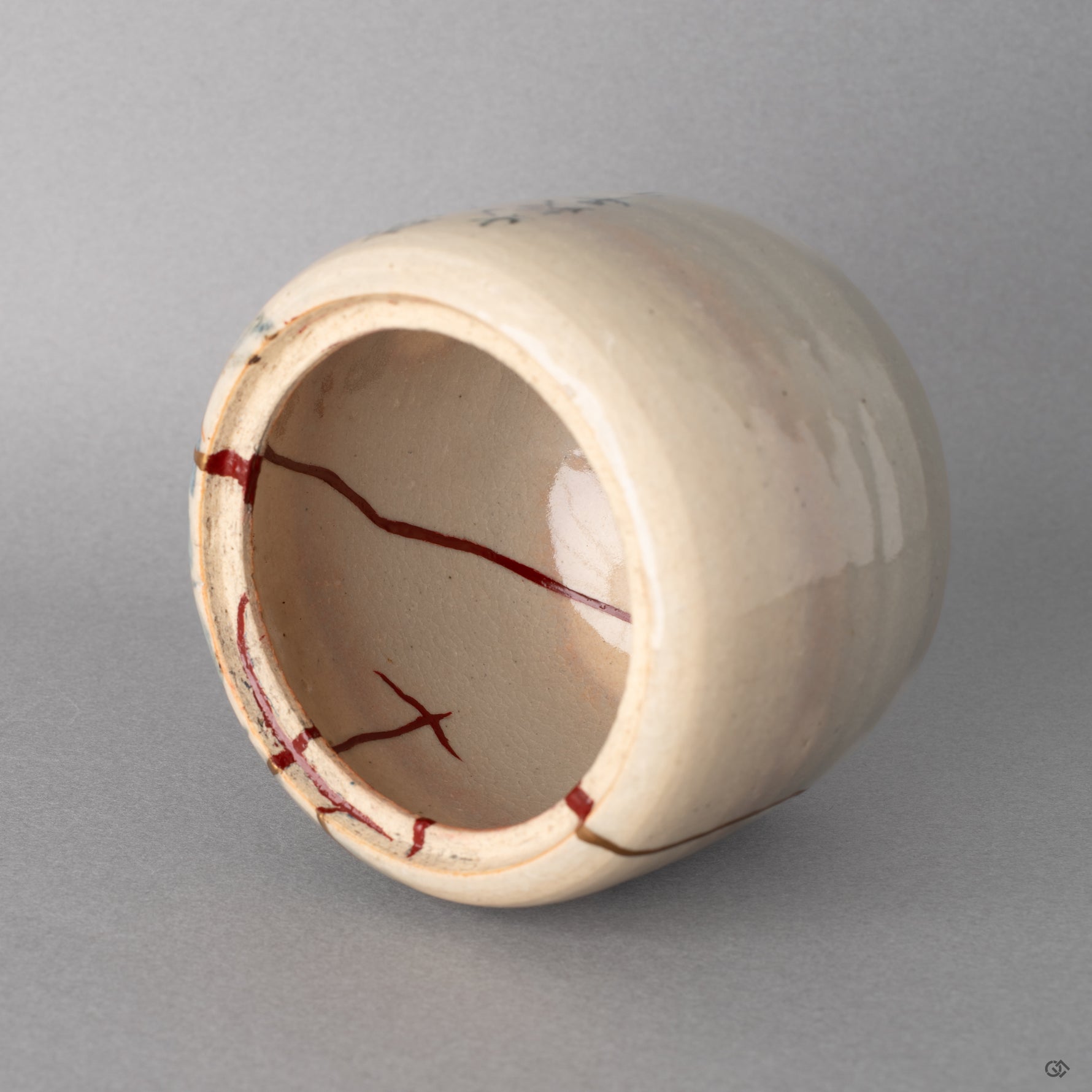 Interior close up of the vermillion urushi restoration. The kintsugi work holds a quiet inherent spiritual elegance.