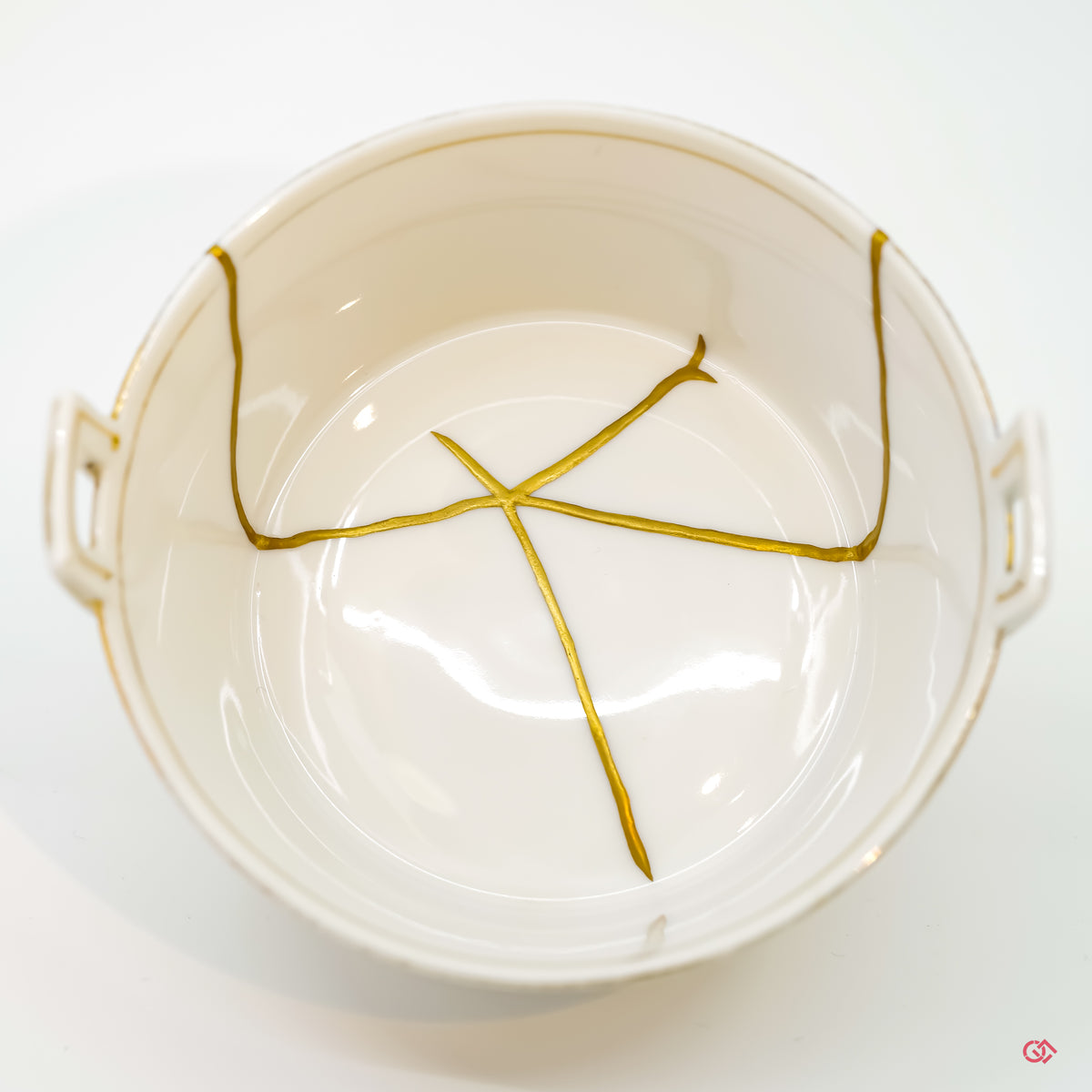 Appreciate the artistry of Kintsugi: Detailed image of pure gold filled cracks in pottery.