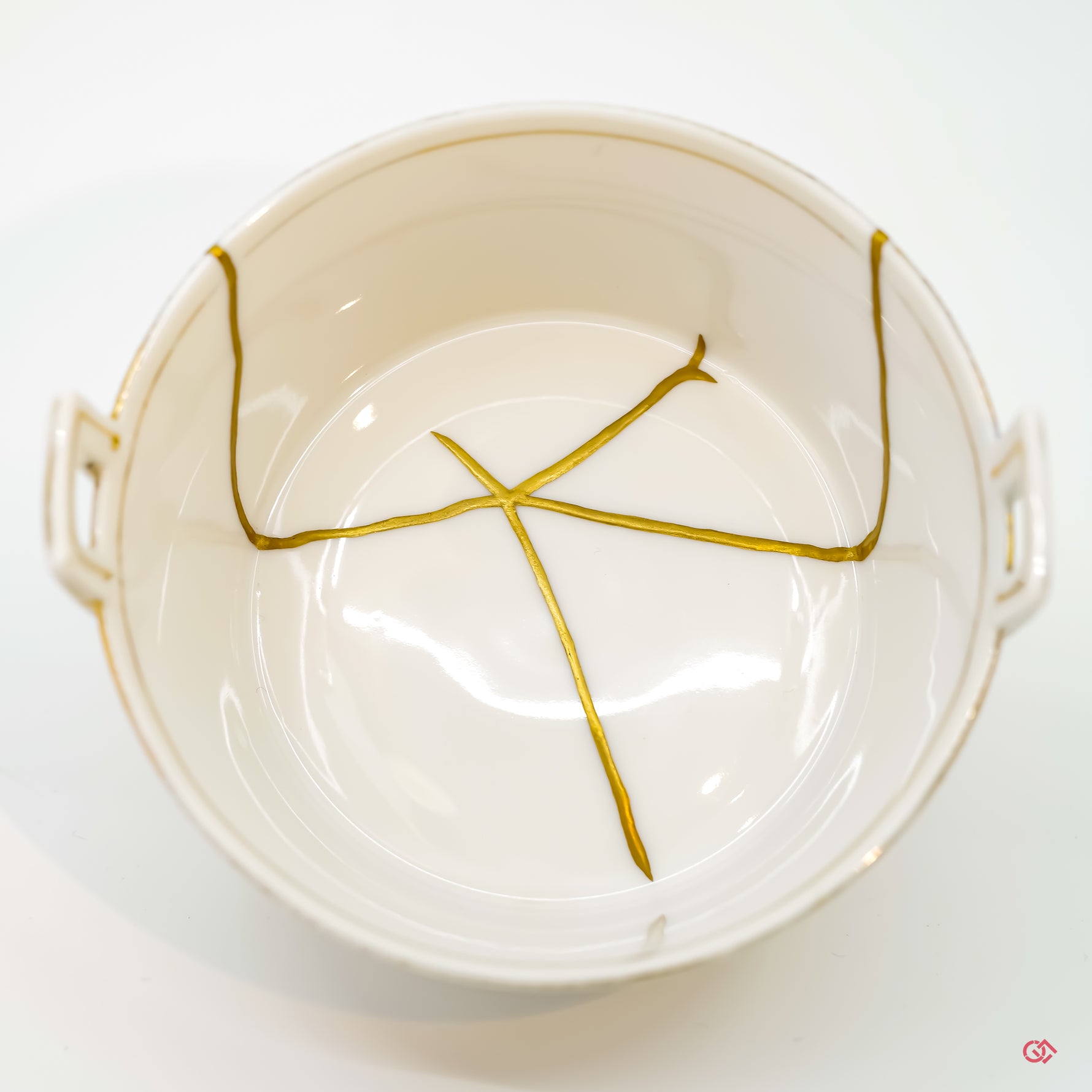 Appreciate the artistry of Kintsugi: Detailed image of pure gold filled cracks in pottery.