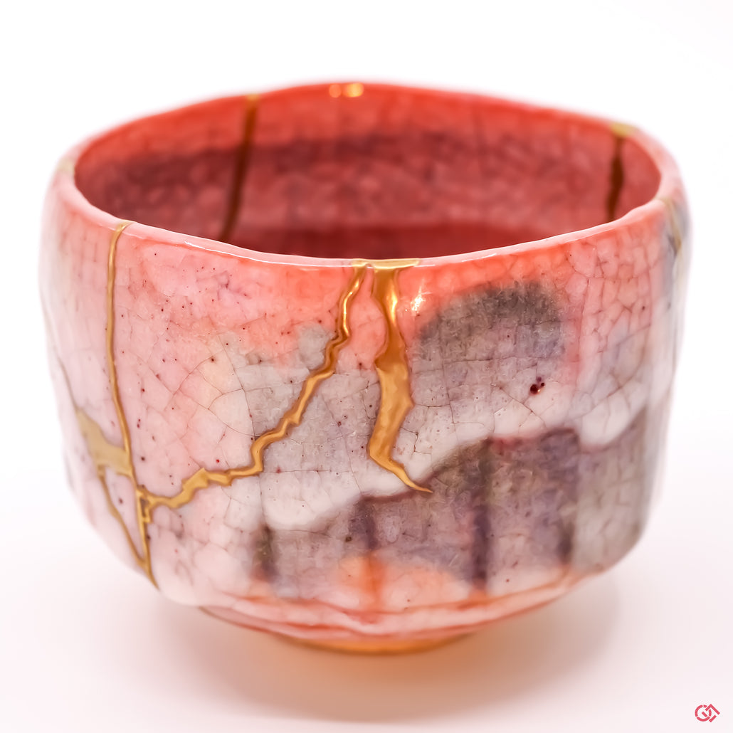 Detailed close-up of authentic Kintsugi pottery, showcasing the delicate gold lines of the repair and the artisan's craftsmanship.