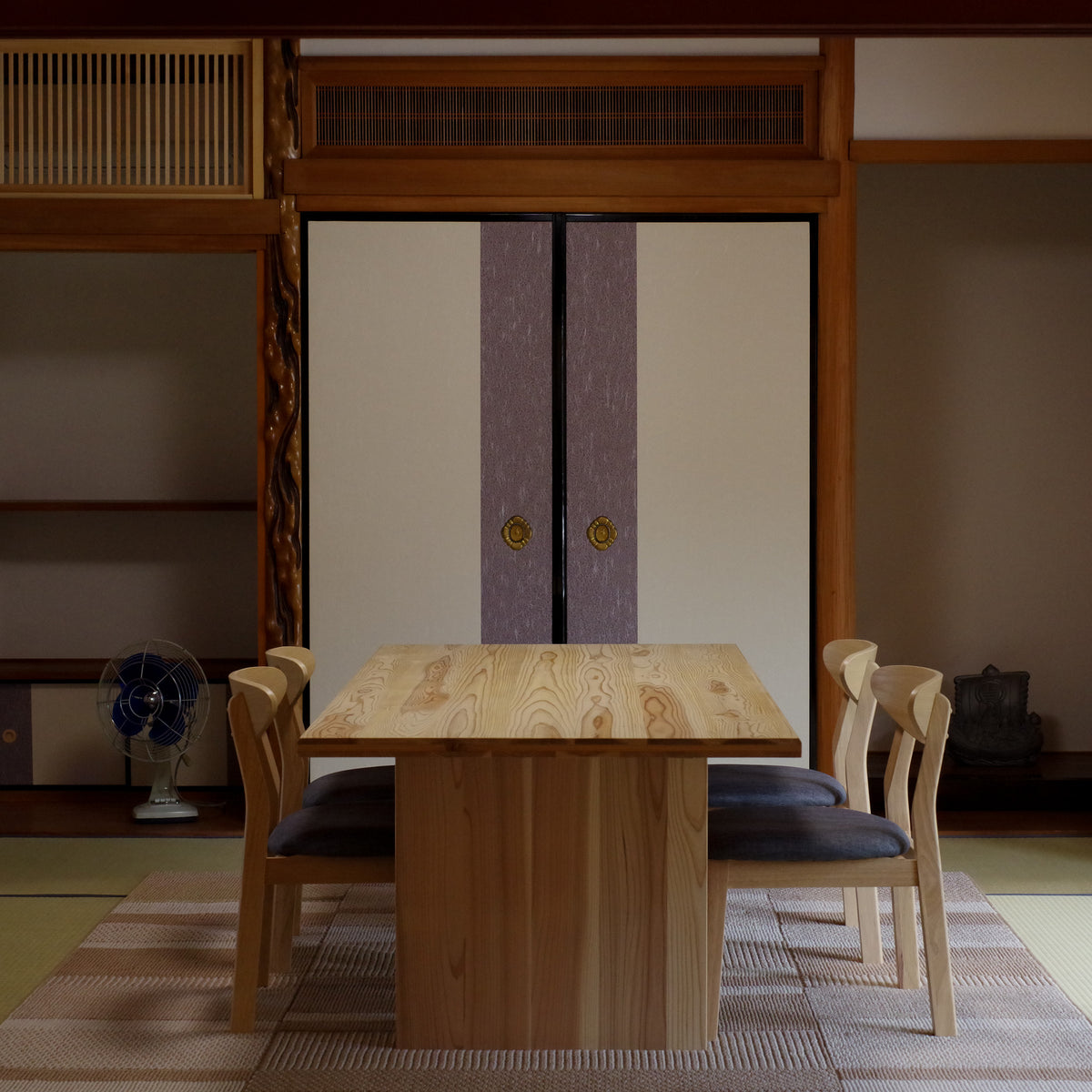 Private viewing room with a wooden table inside a restored Japanese folk house, the Kintsugi Labo gallery in Shiga