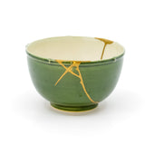 Authentic kintsugi Kyoto ware Oribe sake cup with green glaze and bold 24K gold diagonal line — genuine insight into kintsugi artistry praised by an on-site buyer from Florida.