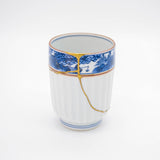 Authentic kintsugi Kyoto ware sake cup Red Sansui with landscape painting and 24K gold repair — a testament to authentic craftsmanship, praised by an on-site buyer from Texas