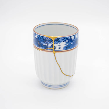 Authentic kintsugi Kyoto ware sake cup Red Sansui with landscape painting and 24K gold repair — a testament to authentic craftsmanship, praised by an on-site buyer from Texas