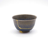 Authentic kintsugi Kyoto ware sake cup Tenmoku Cosmos with deep tenmoku glaze and 24K gold repair — a beautifully restored cup making the perfect gift, praised by a verified buyer from Massachusetts.