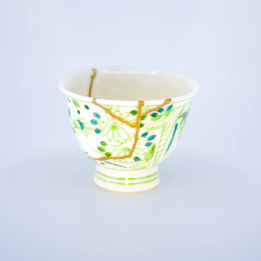 Authentic kintsugi Kyoto ware sake cup Woods with green botanical design and 24K gold repair — a memorable kintsugi journey, praised by an on-site buyer from California.