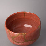 Kintsugi matcha bowl in Raku-style Kyoto ware seen down the front wall, rejoined with natural urushi, 24K gold seams below the rim and at a chip, interior view.
