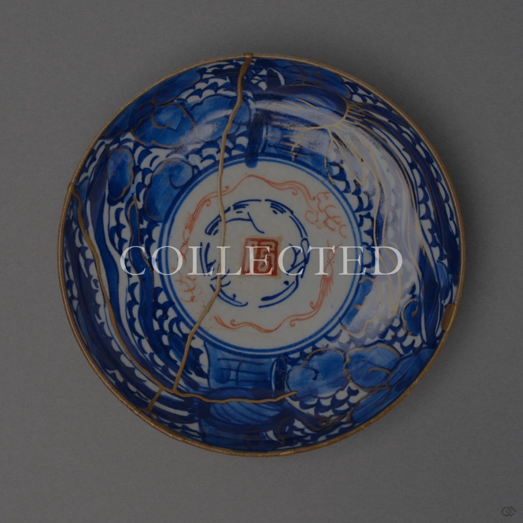Kintsugi plate in Ko-Imari porcelain with sometsuke clouds and a red seal, rejoined with natural urushi, one 24K gold seam crossing from rim to rim. Collected.