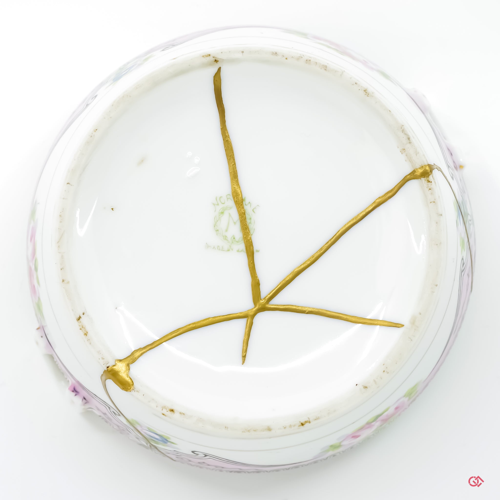 Explore the craftsmanship of Kintsugi: Bottom view of hand-repaired ceramics.