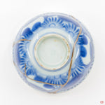 A photo of the bottom of an authentic Kintsugi pottery piece, showing its overall design and features.