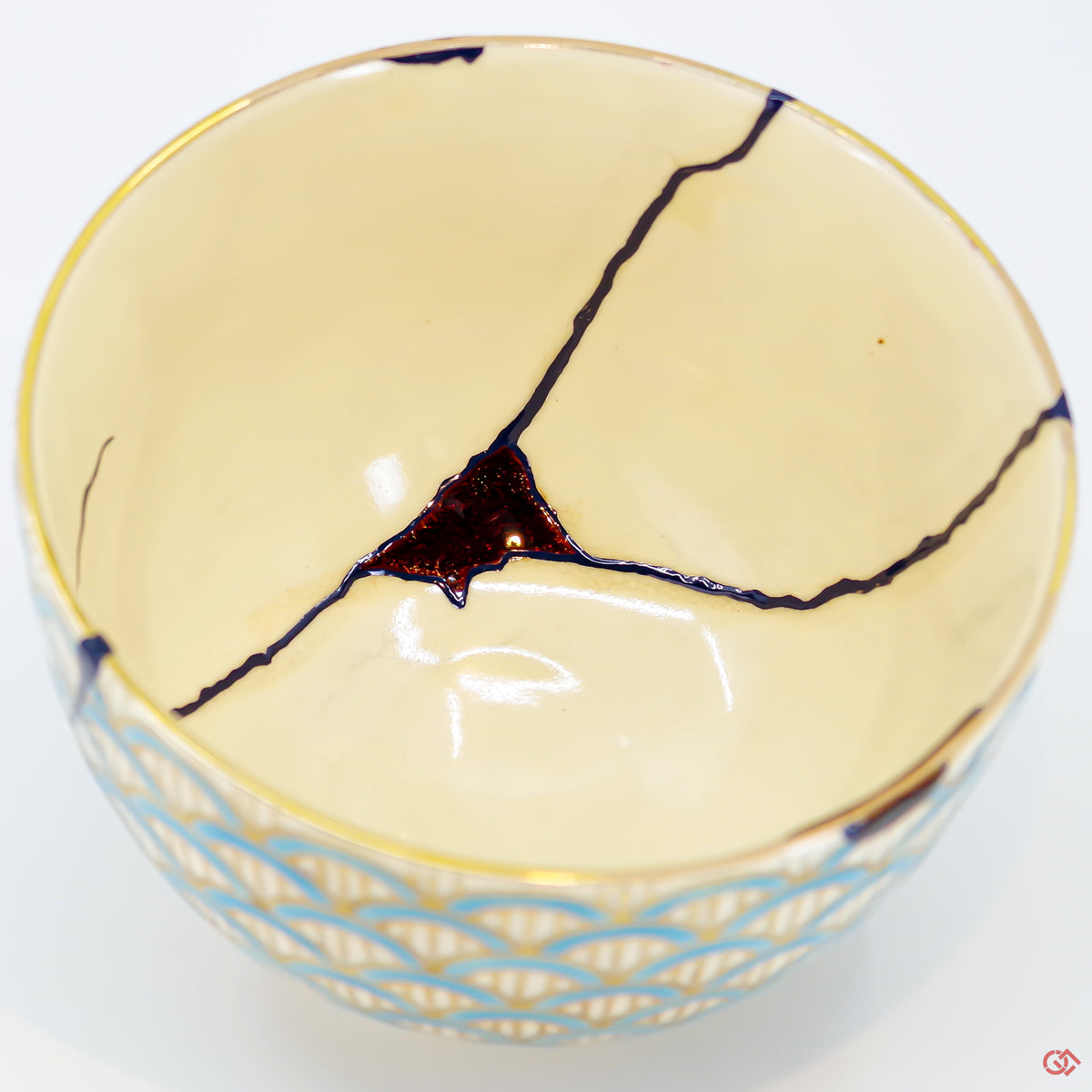 A close-up photo of an authentic Kintsugi pottery piece, showing the detail of its repairs and craftsmanship.