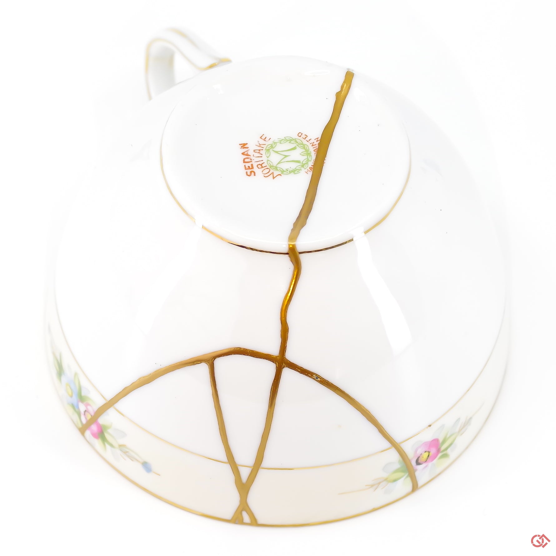 A close-up photo of an authentic Kintsugi pottery piece, showing the detail of its repairs and craftsmanship.