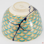 A close-up photo of an authentic Kintsugi pottery piece, showing the detail of its repairs and craftsmanship.