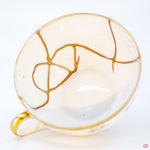 Close-up photo of an authentic Kintsugi pottery piece, showing the detail of its repairs and craftsmanship