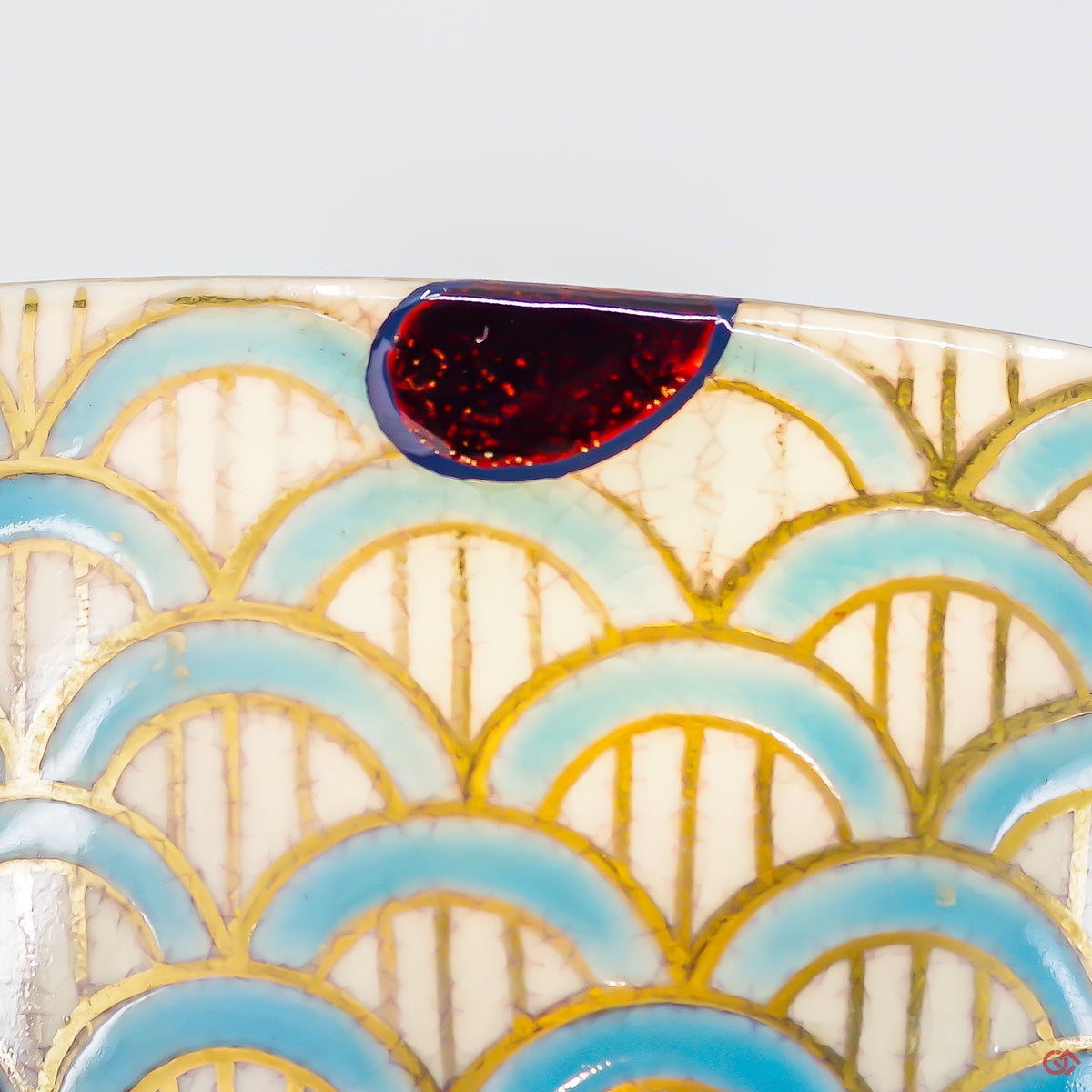A close-up photo of an authentic Kintsugi pottery piece, showing the detail of its repairs and craftsmanship.