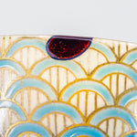 A close-up photo of an authentic Kintsugi pottery piece, showing the detail of its repairs and craftsmanship.