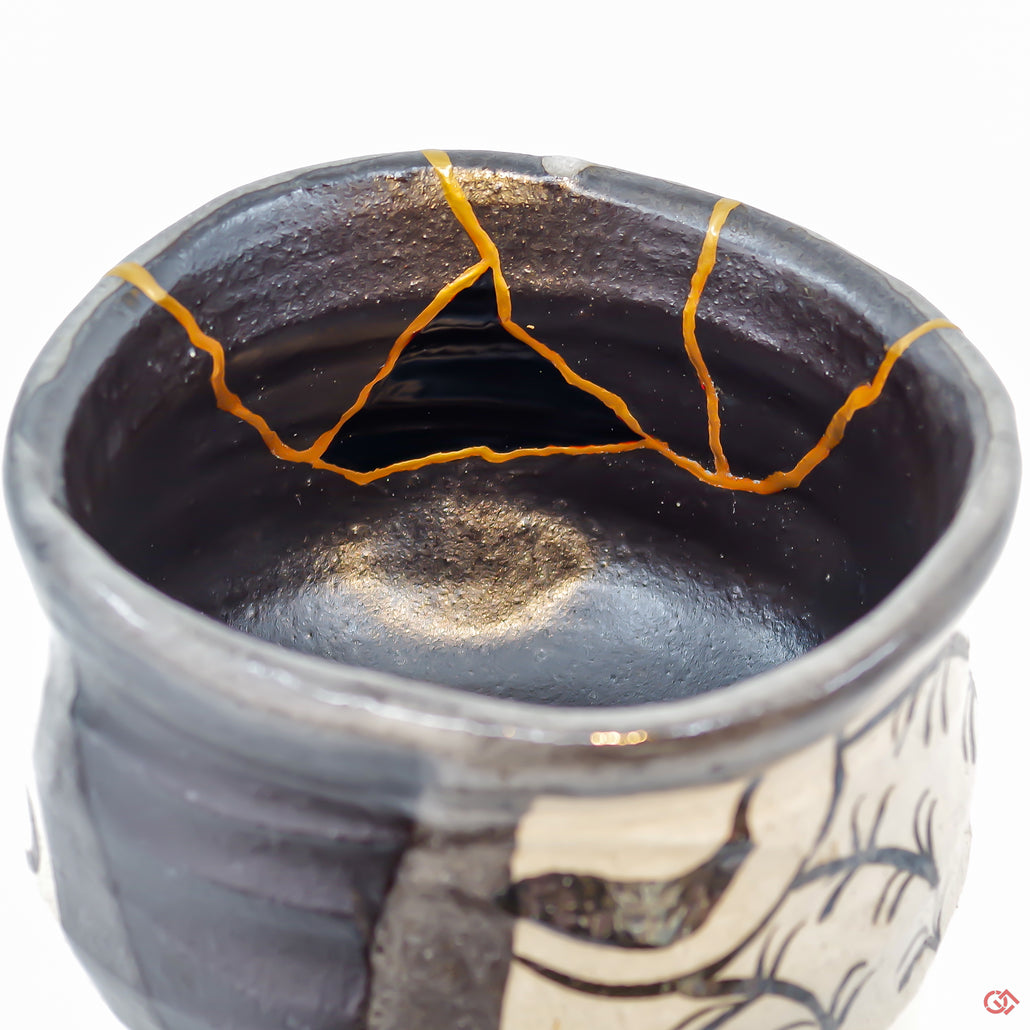 A close-up photo of an authentic Kintsugi pottery piece, showing the detail of its repairs and artisty. craftsmanship.