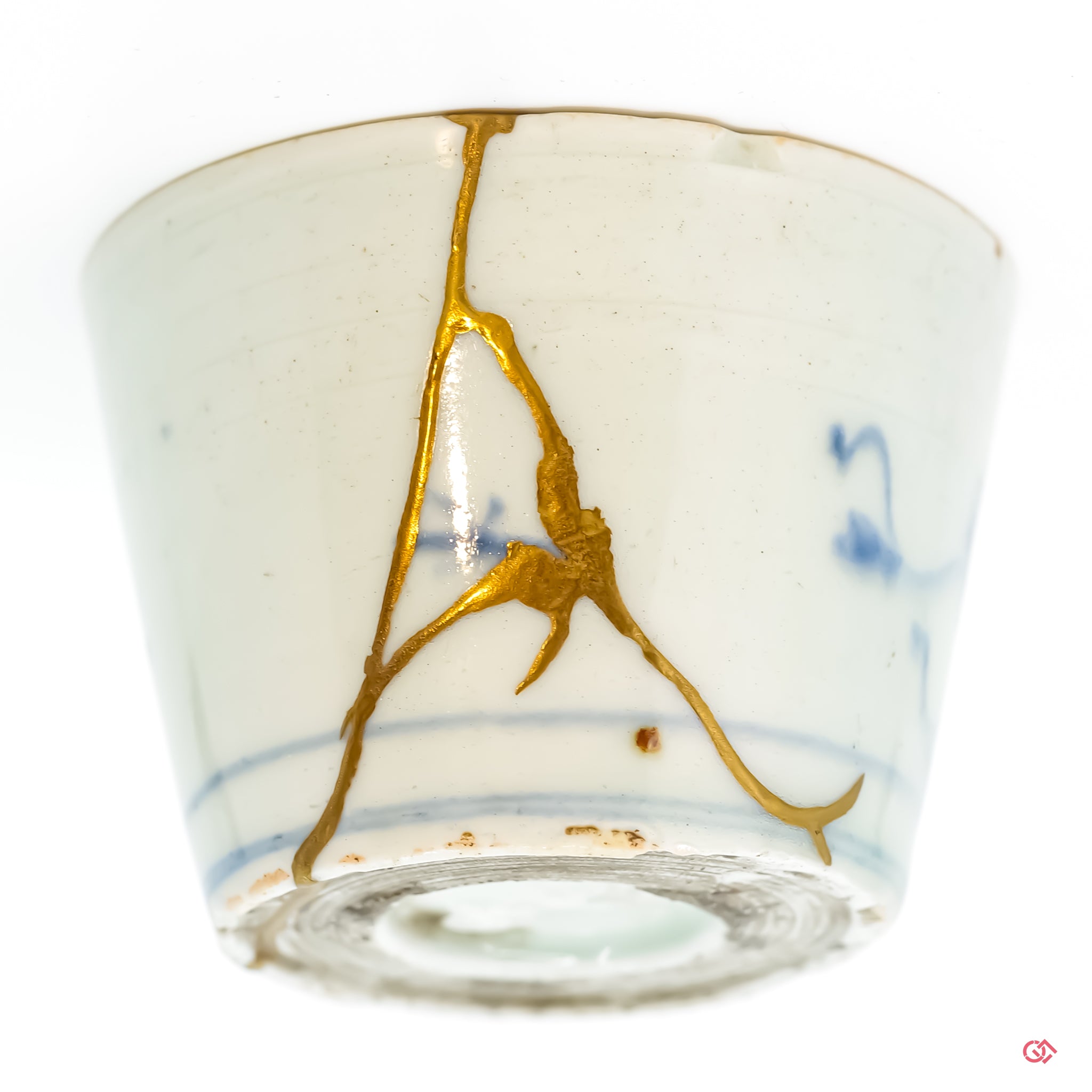 Detailed close-up of authentic Kintsugi pottery, showcasing the delicate gold lines of the repair and the artisan's craftsmanship.