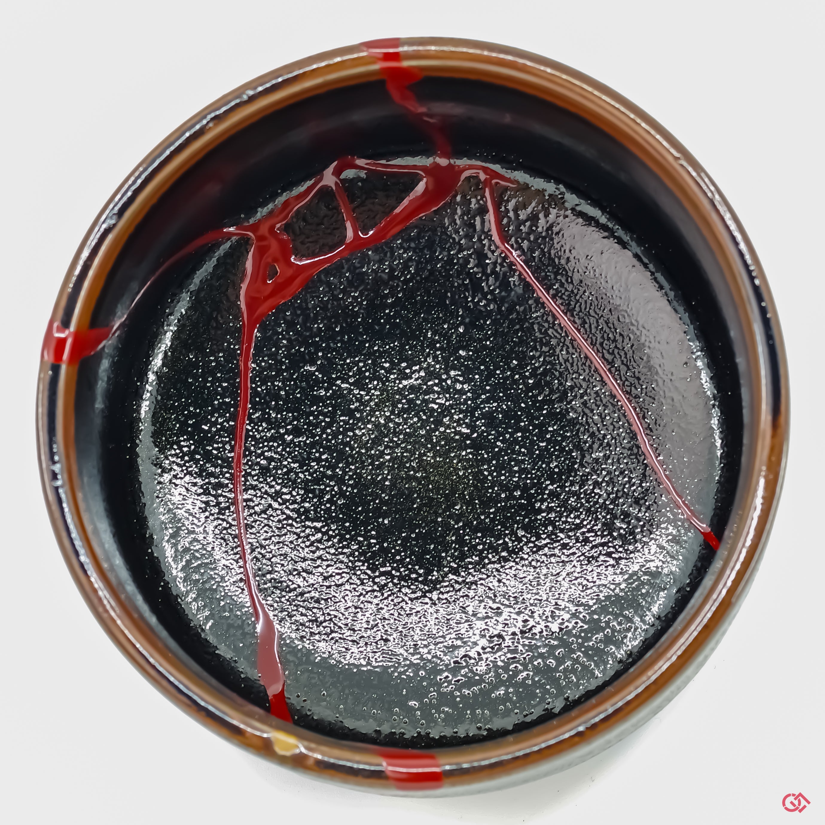 Discover the full beauty of authentic Kintsugi: Top view of repaired pottery.