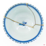 Close up of a kintsugi repaired crack, with clear visual of the gold adhered to the ceramic.